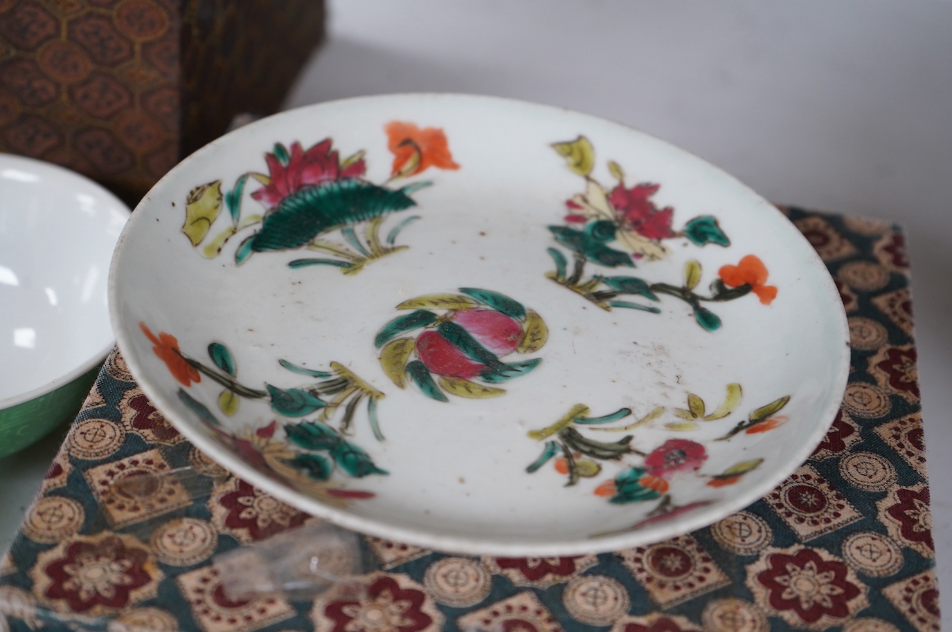 A set of four Chinese green glazed and moulded bowls and a famille rose dish, 19th and 20th century, boxed, largest 17cm. Condition - one bowl cracked